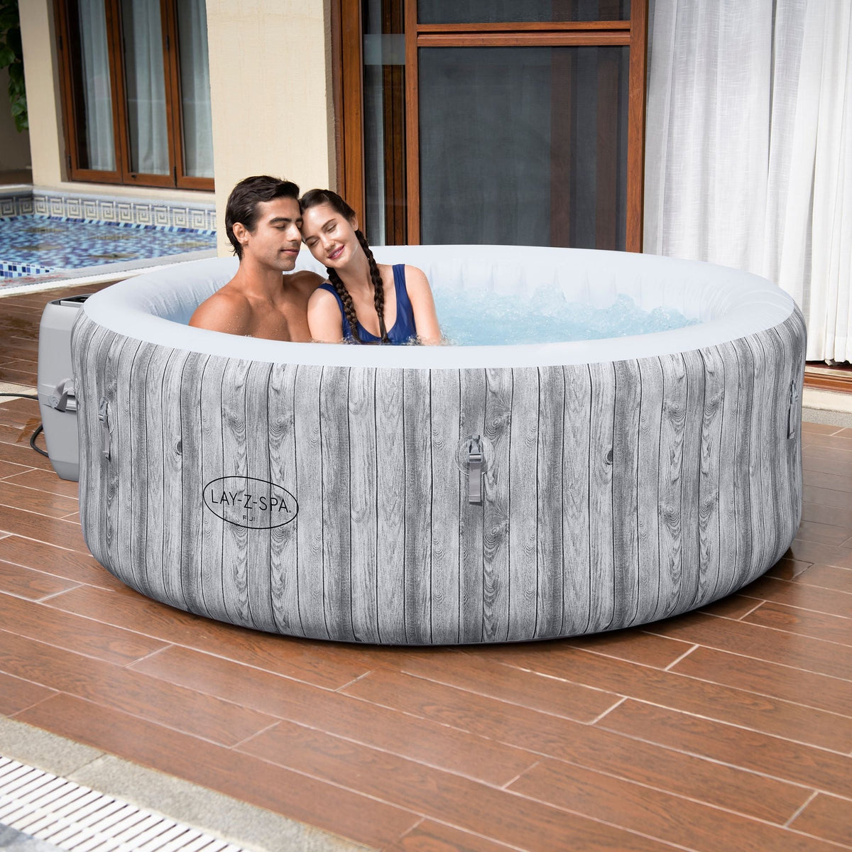 Round Lay-Z-Spa Fiji inflatable hot tub shown in a garden